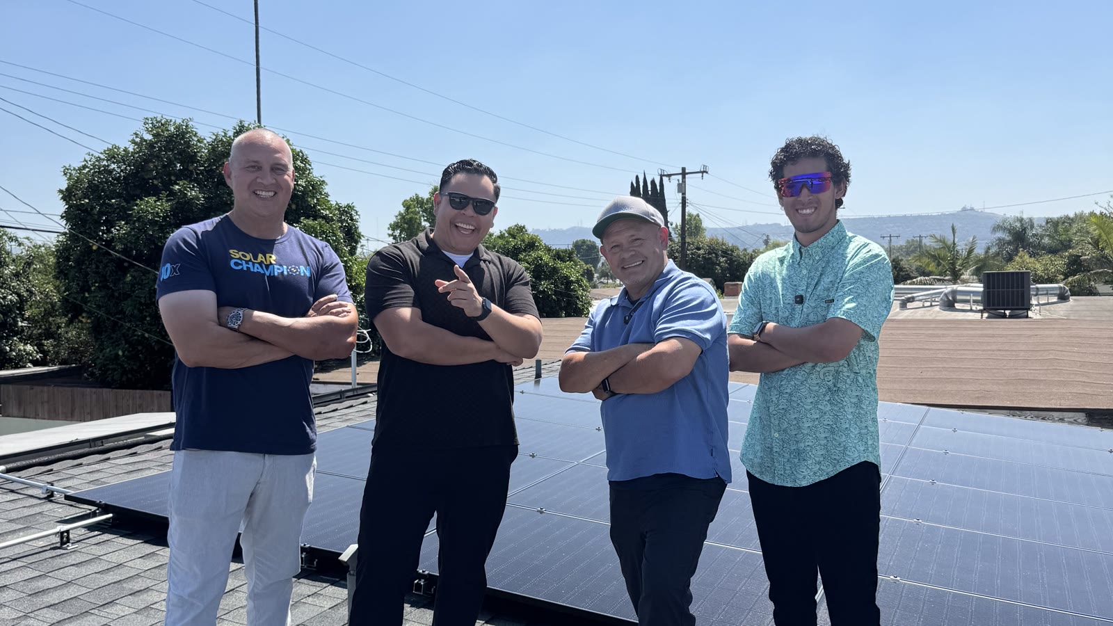 The VertX team standing on a roof in front of a completed solar array